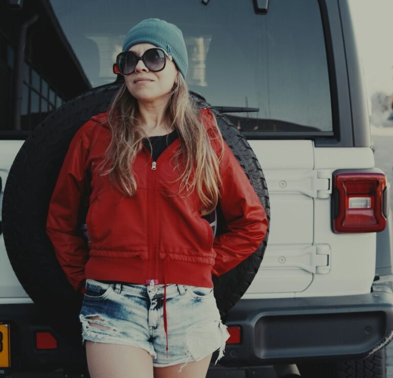 A woman standing in front of a white van